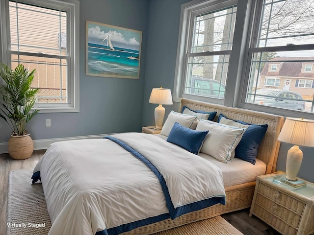 bedroom with wood finished floors and baseboards