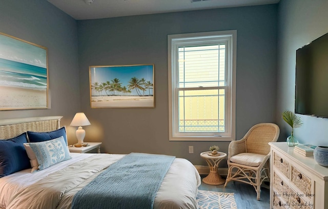 bedroom featuring visible vents and wood finished floors