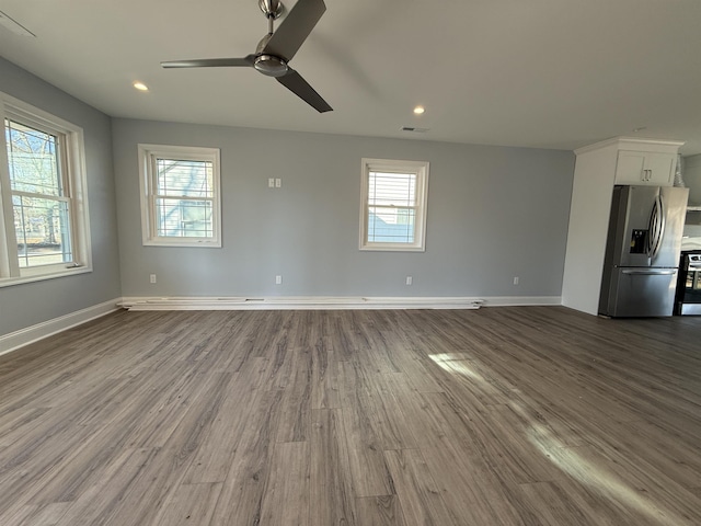 empty room featuring recessed lighting, visible vents, dark wood finished floors, and baseboards