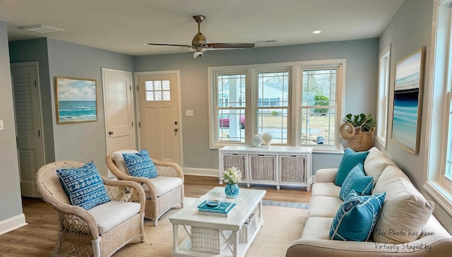 living room featuring recessed lighting, wood finished floors, a ceiling fan, visible vents, and baseboards