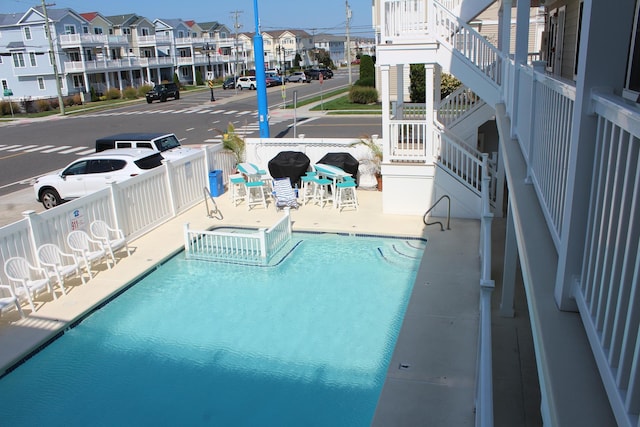 view of pool featuring a patio area and a hot tub