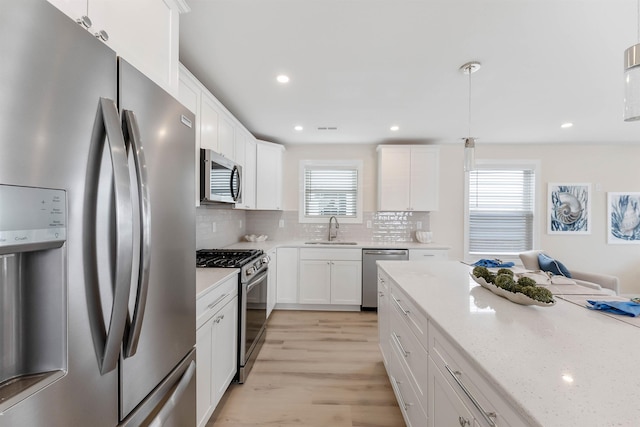 120 W 1st Ave Unit 1, North Wildwood, NJ 08260 - kitchen featuring stainless steel appliances, white cabinets, tasteful backsplash, light wood finished floors, and recessed lighting