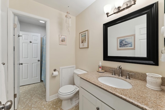 bathroom featuring tile patterned floors, vanity, and toilet