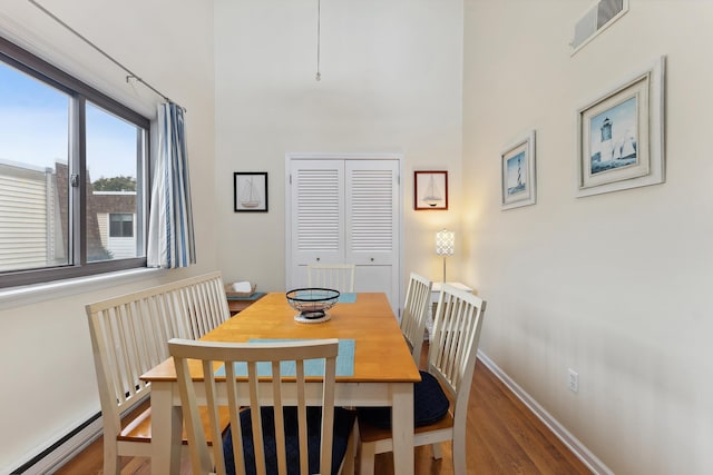 dining area with hardwood / wood-style floors