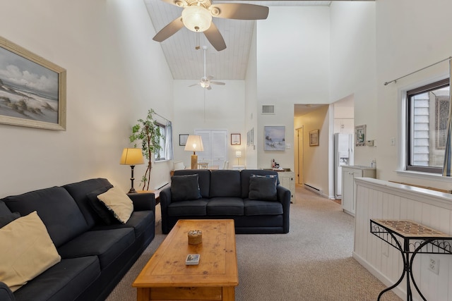 carpeted living room featuring baseboard heating, high vaulted ceiling, and ceiling fan