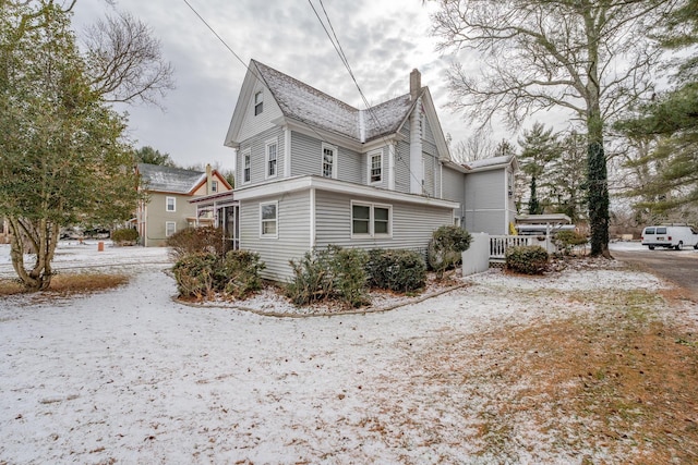 view of front of home with dirt driveway and a carport