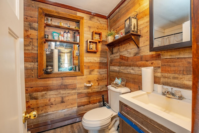 full bath with vanity, toilet, and wooden walls