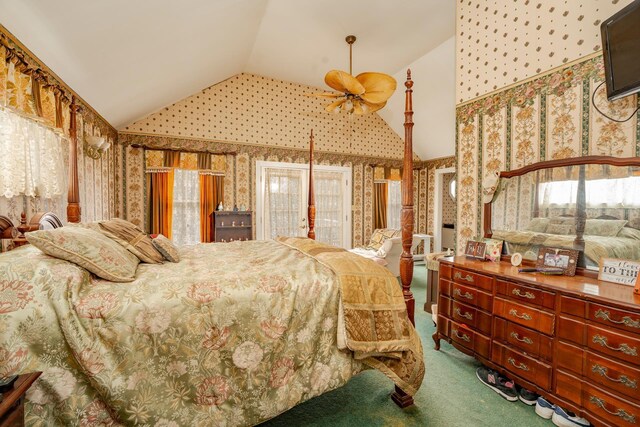 carpeted bedroom with vaulted ceiling and wallpapered walls