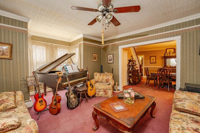 living room featuring carpet floors, wallpapered walls, ceiling fan, and ornamental molding