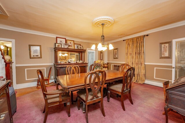 carpeted dining space with crown molding, a baseboard radiator, and a notable chandelier