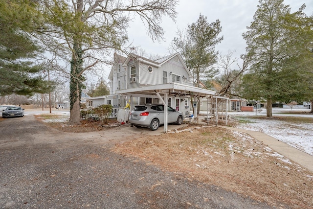 view of front of house featuring a carport and dirt driveway