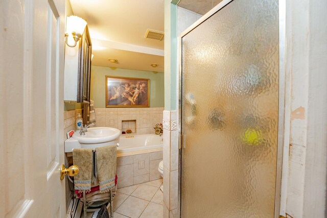 full bathroom featuring tile patterned flooring, a sink, visible vents, a shower stall, and a bath