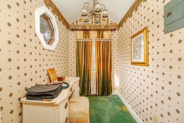 interior space with lofted ceiling, baseboards, an inviting chandelier, and wallpapered walls