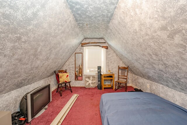 bedroom featuring carpet floors, vaulted ceiling, and a textured ceiling