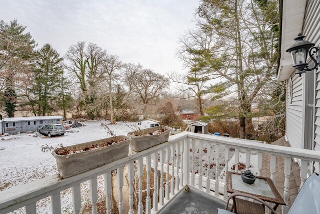 view of snow covered back of property