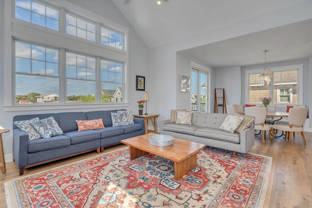 243 87th St, Stone Harbor, NJ 08247 - living area featuring wood finished floors, plenty of natural light, high vaulted ceiling, and baseboards