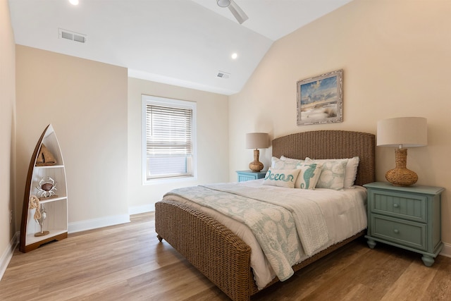 bedroom with vaulted ceiling and light hardwood / wood-style flooring