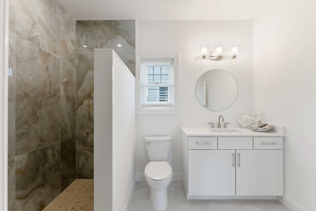 bathroom featuring vanity, toilet, and tiled shower