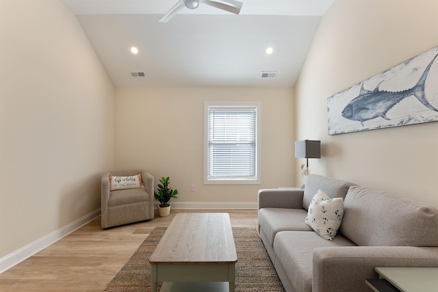 living room featuring ceiling fan, lofted ceiling, and light hardwood / wood-style flooring