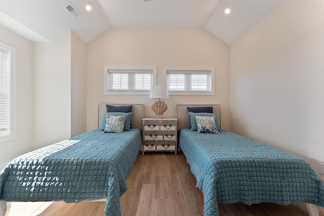 bedroom featuring lofted ceiling and light hardwood / wood-style floors