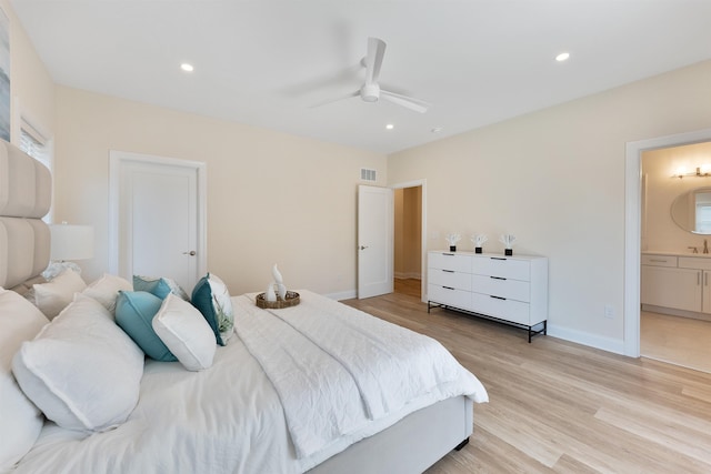 bedroom featuring ensuite bathroom, ceiling fan, and light hardwood / wood-style flooring