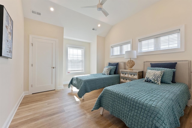 bedroom with ceiling fan, lofted ceiling, and light hardwood / wood-style floors