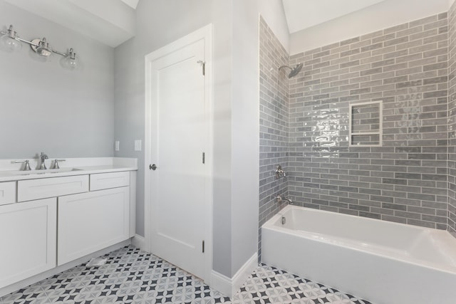 bathroom with vanity and tiled shower / bath combo