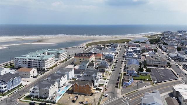 drone / aerial view with a water view and a beach view