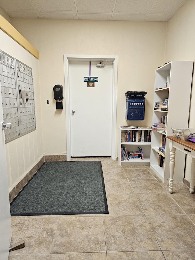 interior space featuring a paneled ceiling and mail boxes