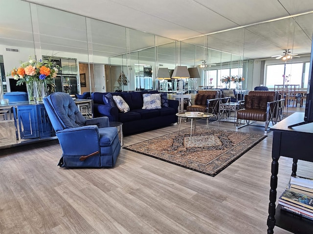 living room featuring ceiling fan and light hardwood / wood-style flooring