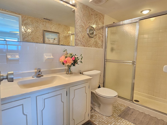 bathroom featuring vanity, tile walls, an enclosed shower, and toilet