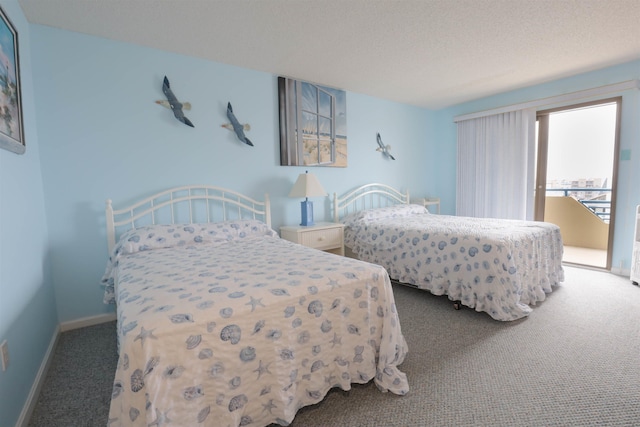 bedroom with carpet and a textured ceiling