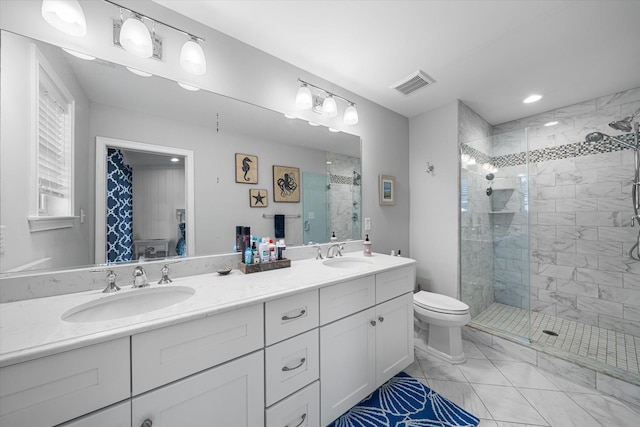 bathroom with vanity, toilet, and a shower with shower door