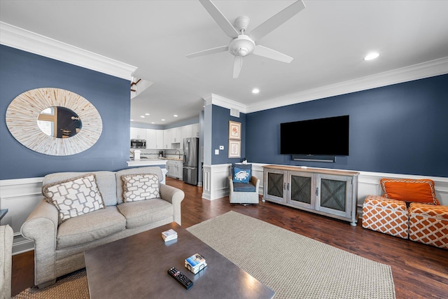 living room with dark hardwood / wood-style floors, ceiling fan, and crown molding