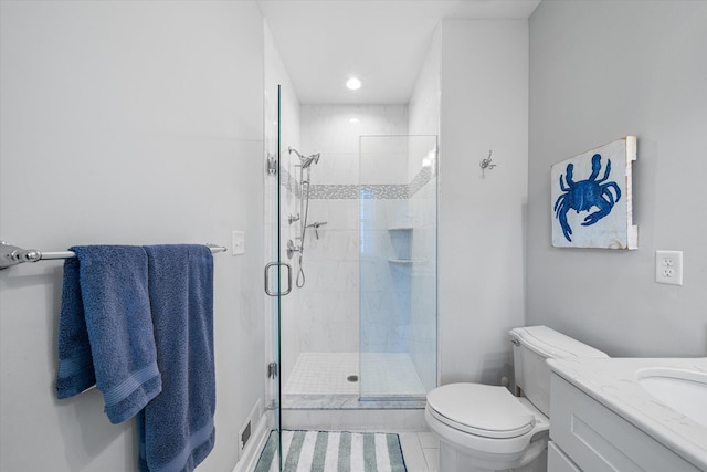 bathroom featuring tile patterned flooring, vanity, toilet, and walk in shower