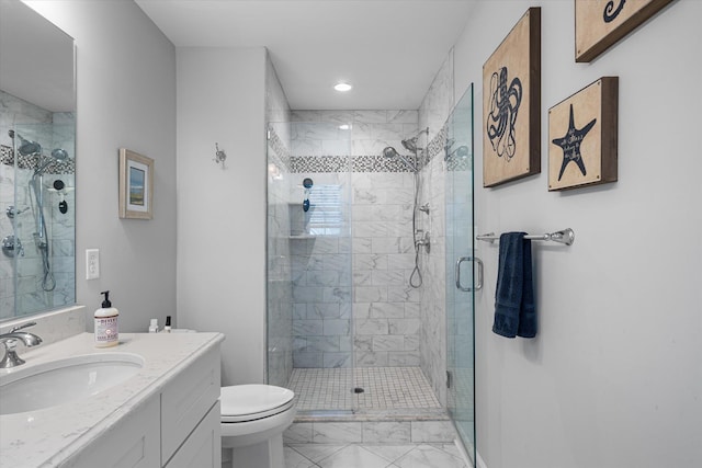 bathroom featuring vanity, toilet, and walk in shower