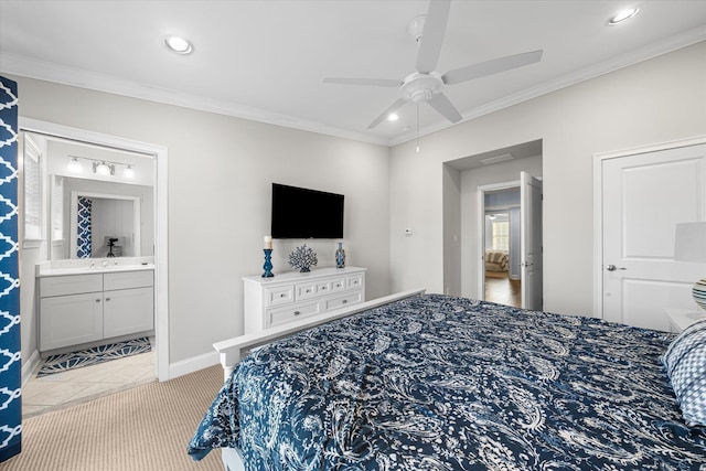 bedroom with ceiling fan, light colored carpet, ornamental molding, and ensuite bath