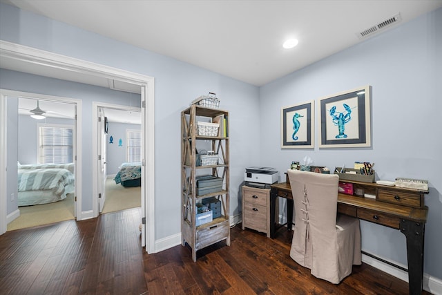 home office with ceiling fan and dark wood-type flooring