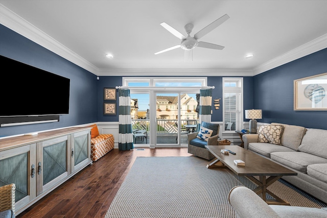 living room with dark wood-type flooring, ceiling fan, and crown molding