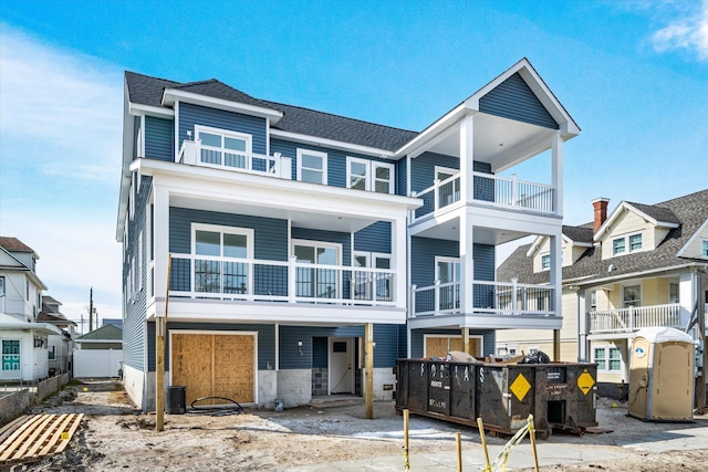 view of front of home with a residential view and roof with shingles