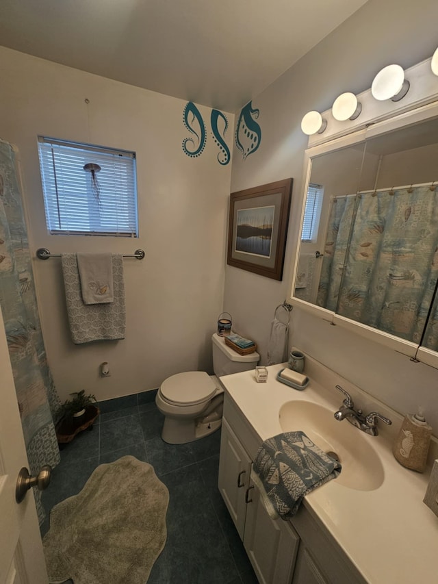 bathroom featuring vanity, tile patterned flooring, and toilet