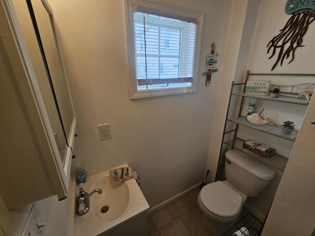 bathroom with vanity, toilet, and tile patterned flooring