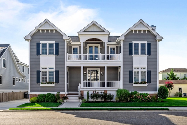 view of front of property featuring covered porch and a balcony