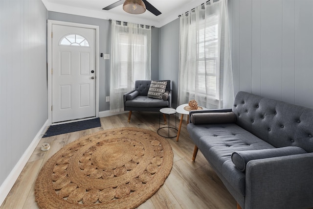 entrance foyer featuring ceiling fan, wood finished floors, and baseboards