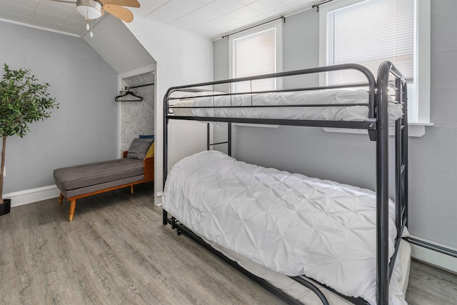 bedroom featuring ceiling fan, wood finished floors, and baseboards