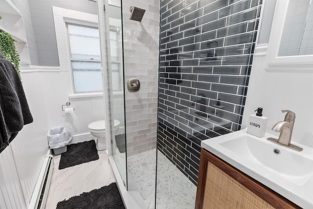 bathroom with marble finish floor, tiled shower, toilet, and baseboard heating