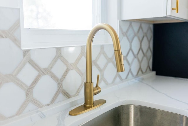 details featuring white cabinetry and a sink