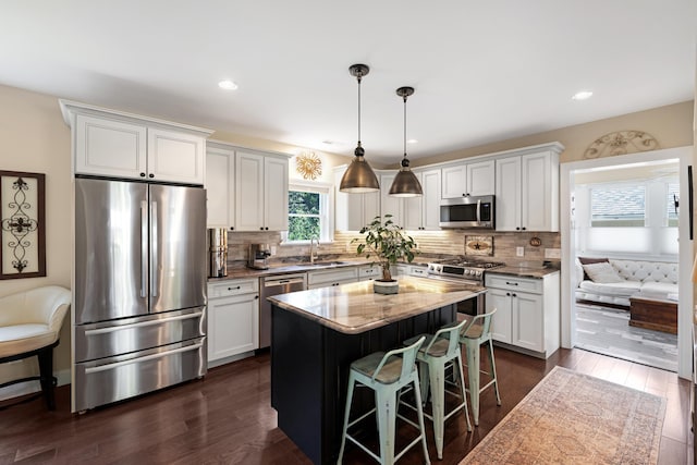735 Maple Ave, West Cape May, NJ 08204 - kitchen with appliances with stainless steel finishes, white cabinets, a breakfast bar area, tasteful backsplash, and recessed lighting