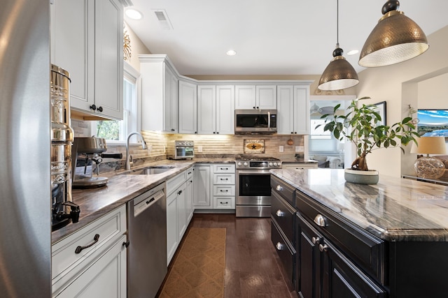 735 Maple Ave, West Cape May, NJ 08204 - kitchen with stainless steel appliances, dark cabinetry, dark stone countertops, dark wood finished floors, and recessed lighting