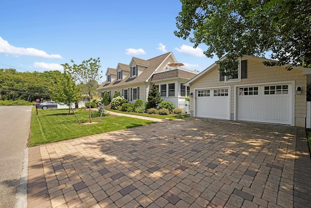 735 Maple Ave, West Cape May, NJ 08204 - view of front of home featuring a front lawn, decorative driveway, and an outbuilding